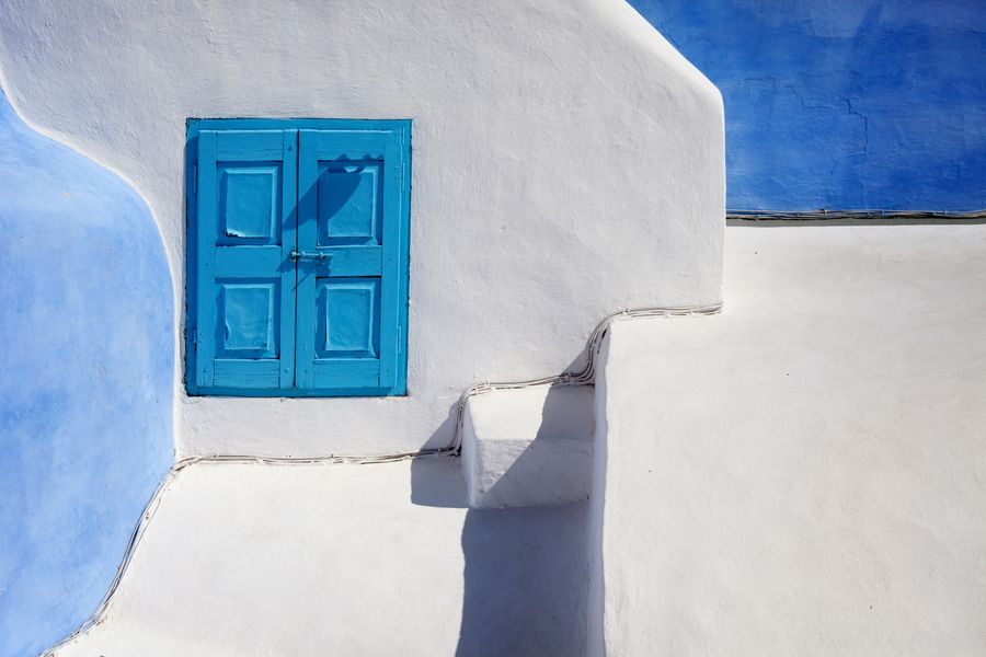 a blue wooden door on a white concrete wall — The modern arrival: online before the seatbelt sign goes off.