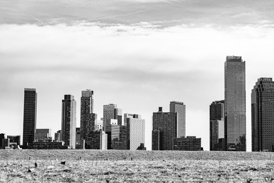 grayscale photograph of high rise buildings in new york — A nivel de calle: navegación, traslados y reseñas, todo al instante.