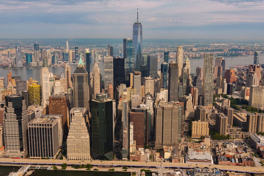 photo of city buildings — Coworking abroad: laptop tethered, calls crisp, deadlines met.