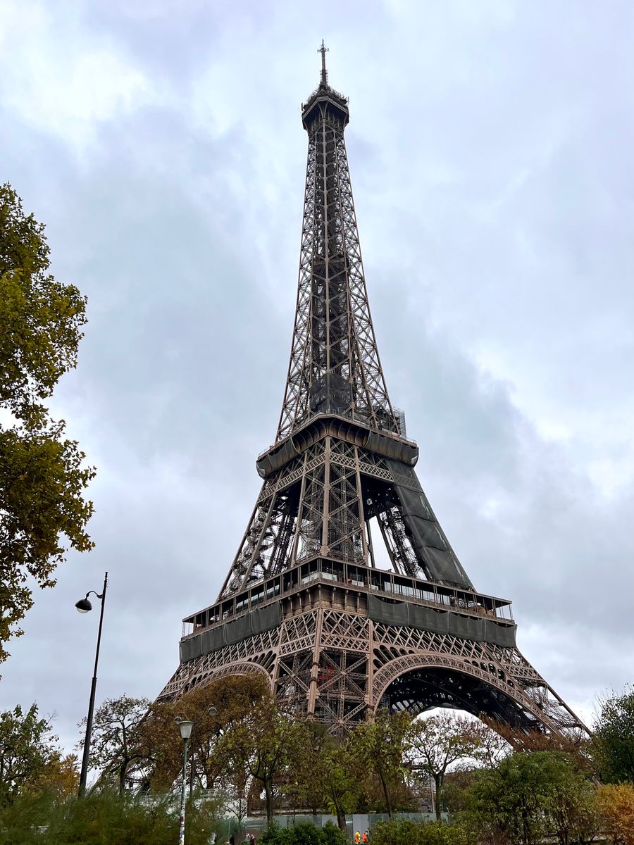 low angle photo of eiffel tower under cloudy sky — Golden hour, fully online — photo backups upload before dinner.