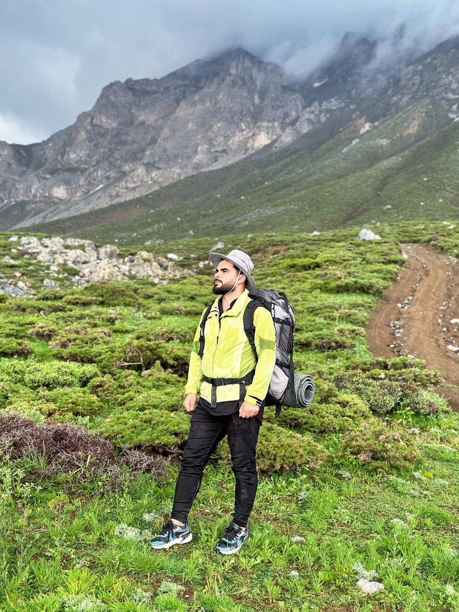 man wearing yellow jacket in a mountain valley — Oficinas-café en Colombia: zona wifi estable, sin ruleta de wifi de hotel.