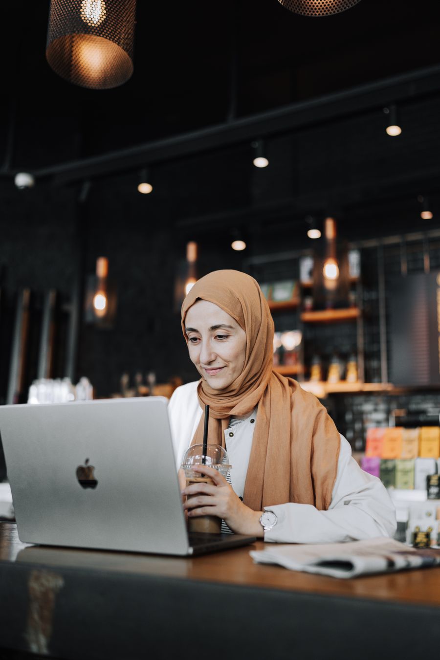 woman using laptop at cafe