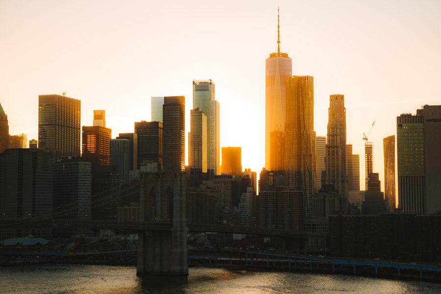 rising sun behind nyc downtown — Island time, online time: ferries, beaches and full signal.