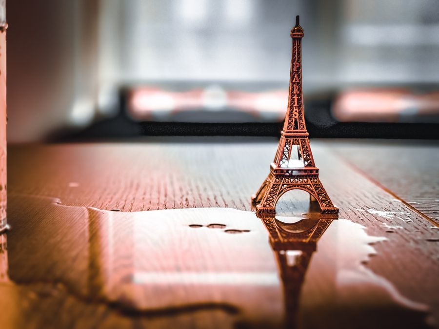 miniature eiffel tower reflected on wet surface — Multi-Country eSIM Guide accepts your trip details and hands back a clear recommendation.