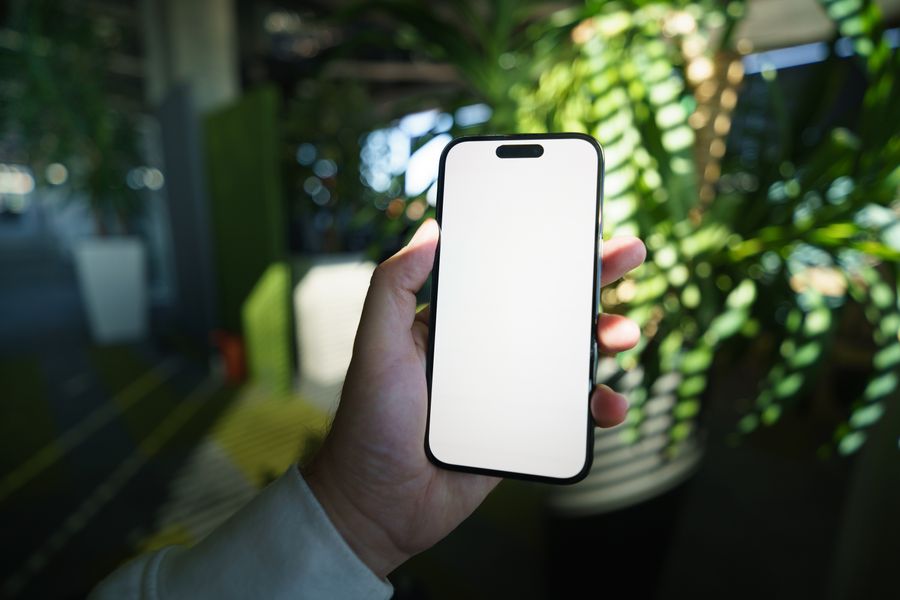 blank smartphone screen in modern office setting