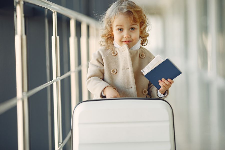 cute little girl with suitcase and passport — The night bus: entertainment downloaded, messages queued, rest easy.