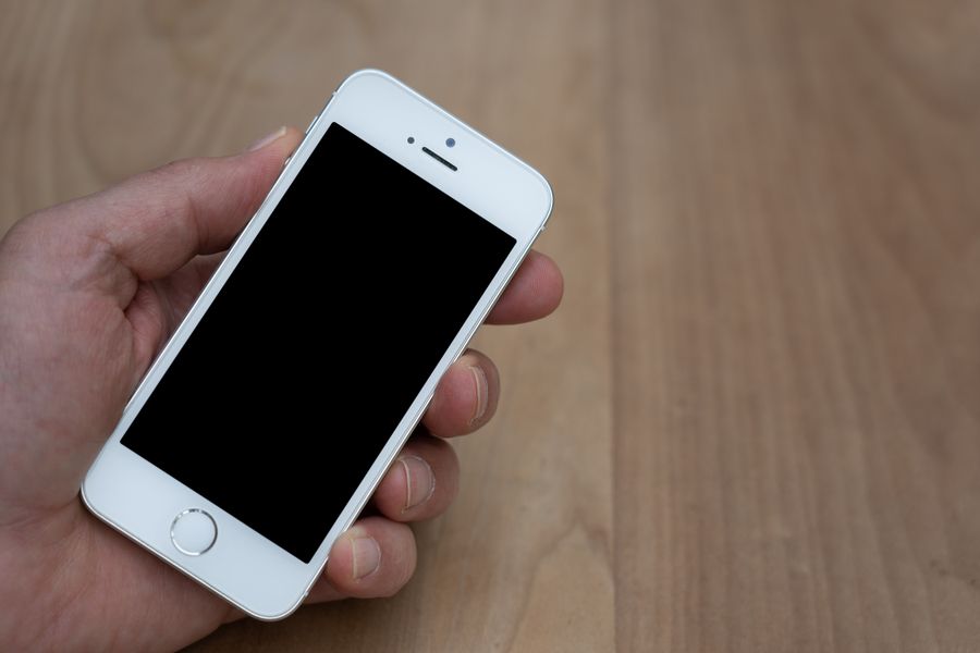 a smartphone with a black screen — Built mobile-first, because travel questions happen on phones.