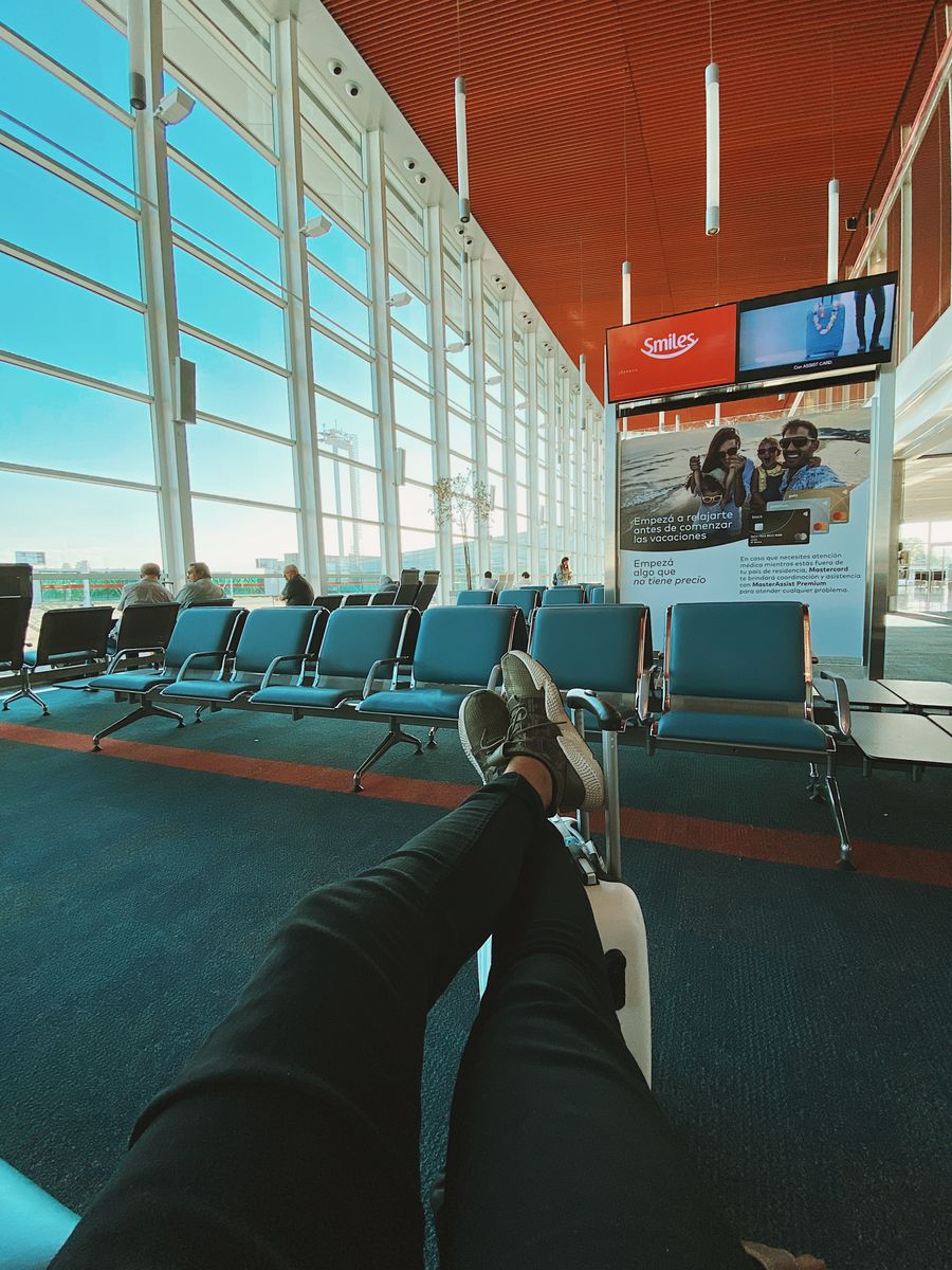 man waiting for flight in airport — Night markets and late trains — connected the whole way through.