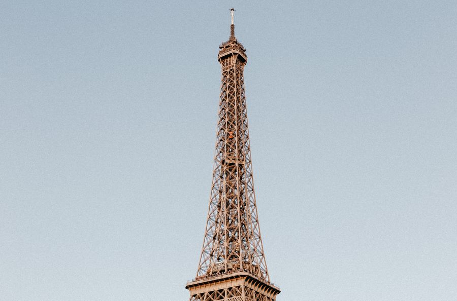 photo of the eiffel tower under a blue sky