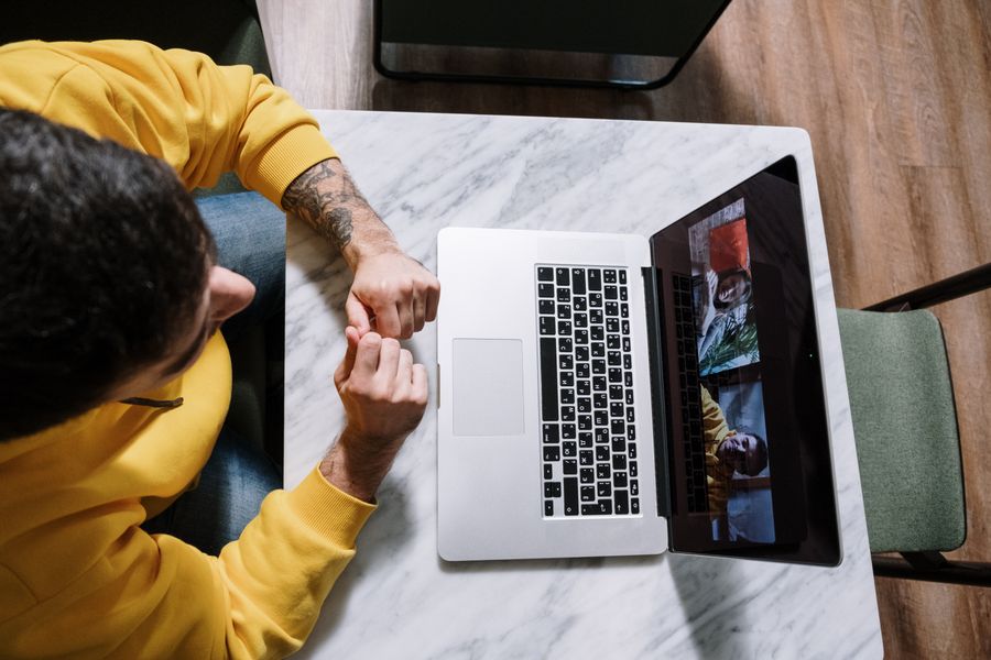 man and woman video call on laptop — Rain or shine, the connection holds — weather doesn't throttle data.