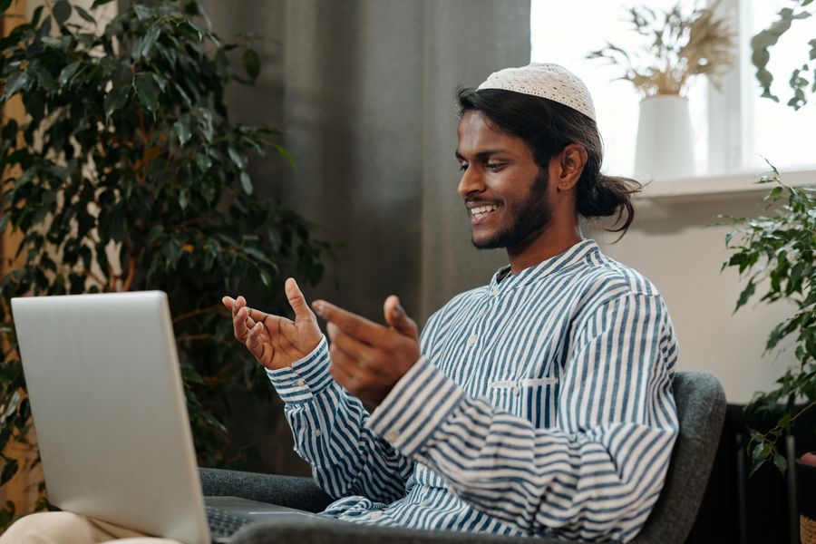 man video calling using a laptop while sitting on a chair — Data Usage Estimator works for anonymous visitors — answers first, signup never forced.