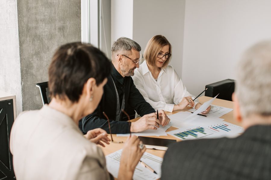 elderly man and woman looking at documents