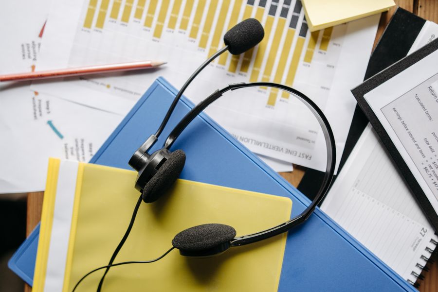 a close up shot of a headset on documents — eSIM Troubleshooter runs in your browser session — nothing sensitive stored against you.