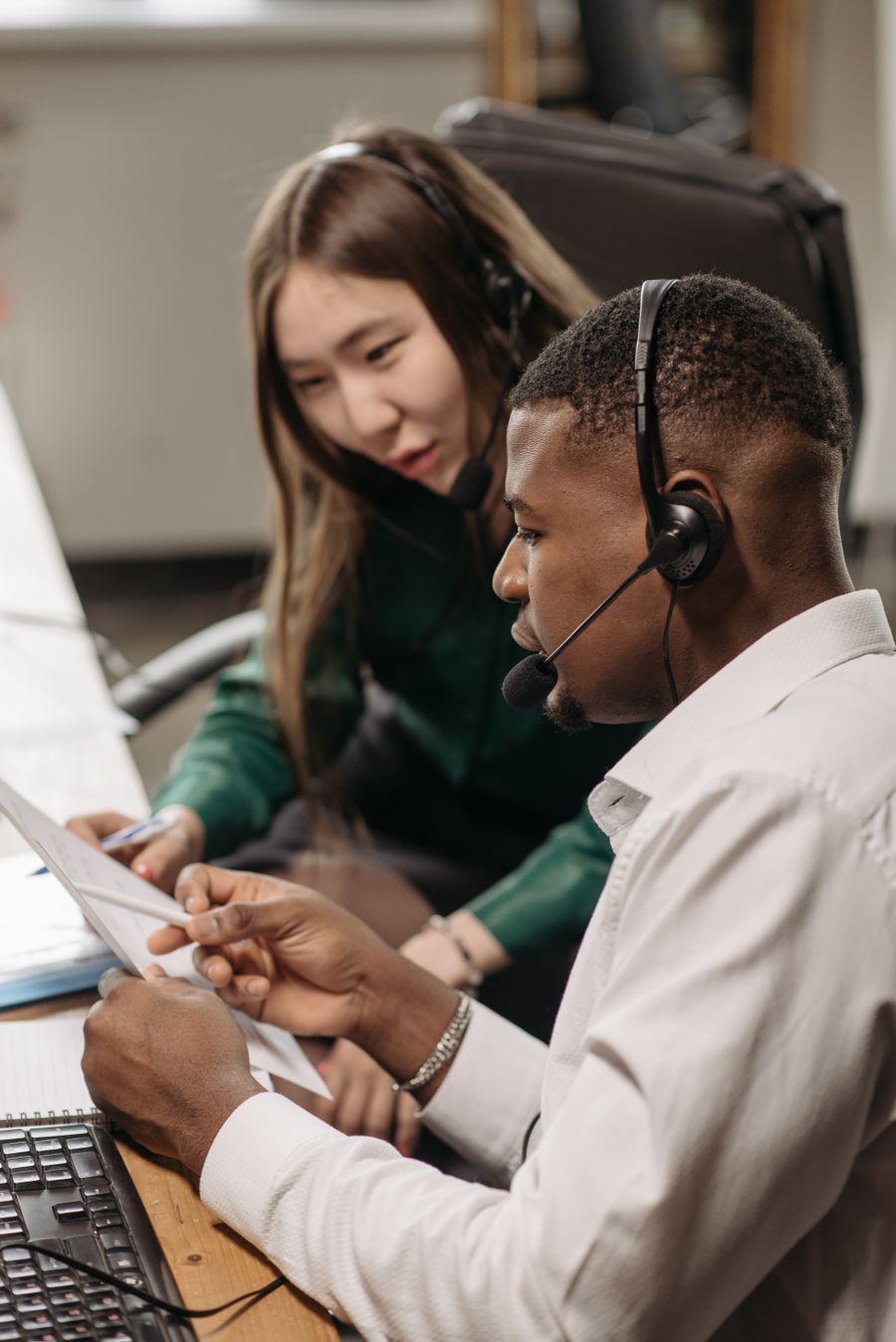 a man and woman having conversation while wearing headsets
