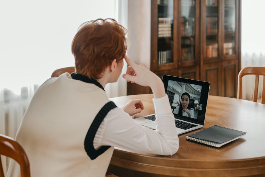 a man having a video call on his laptop
