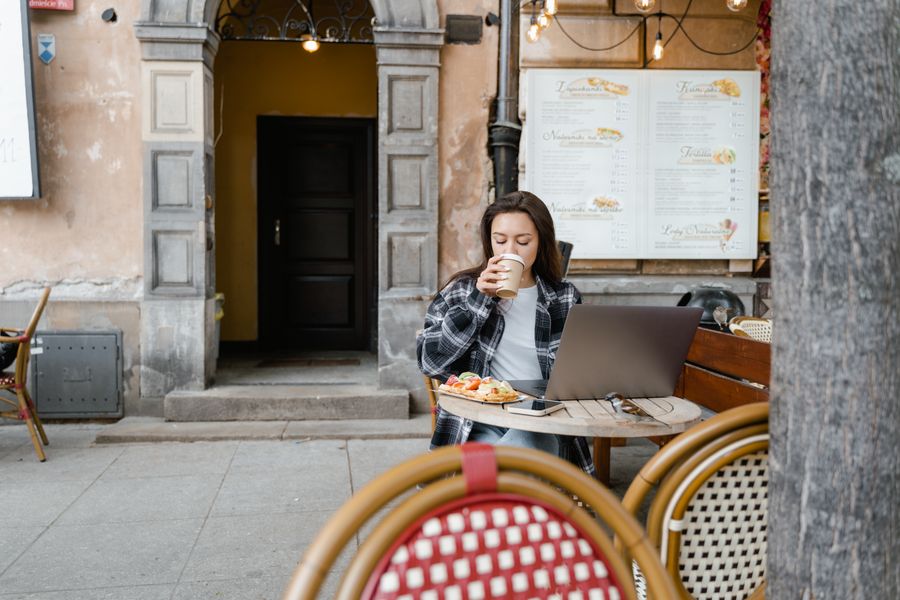 brunette woman drinking a cup of coffee