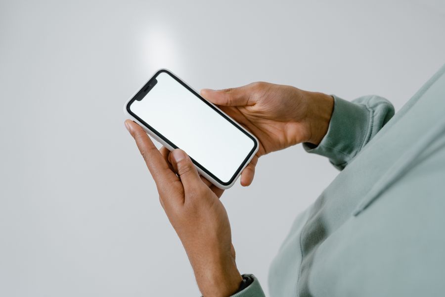 photo of a person holding a smartphone — Prefer conversation? The Tele Agent answers the same questions with the same data.